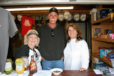 Image: Welcome to Grandview! — These friendly smiles operating the concession stand belong to Darla Dudley who owns ReMax®, John Taggart who owns Burgundy Beef and Jackie Wheeler who owns Texas Sports Builders and is the Vice President of the Grandview Booster Club that promotes a safe and drug-free playing field.