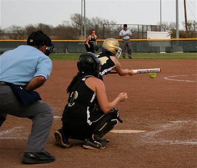 Image: Bunting season — Trying to bunt her way to first base is Italy’s Morgan Cockerham.