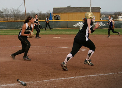 Image: Bunt and run — Katie Byers tries to beat the throw to first base.