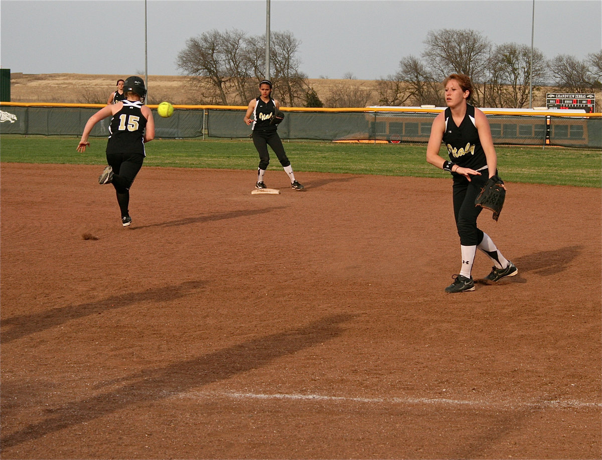 Image: Team work — Lady Gladiator second baseman, Bailey Bumpus, calmly throws to first baseman, Paige Westbrook, for an out as Anna Viers covers second base from her shortstop position.