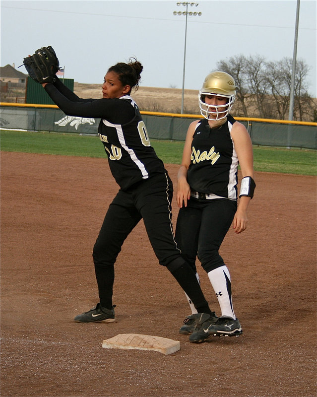 Image: Show respect — Meridian is respecting the speed of Megan Richards and tries to keep her close to first base.