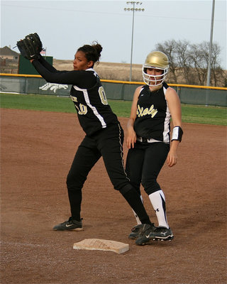 Image: Show respect — Meridian is respecting the speed of Megan Richards and tries to keep her close to first base.