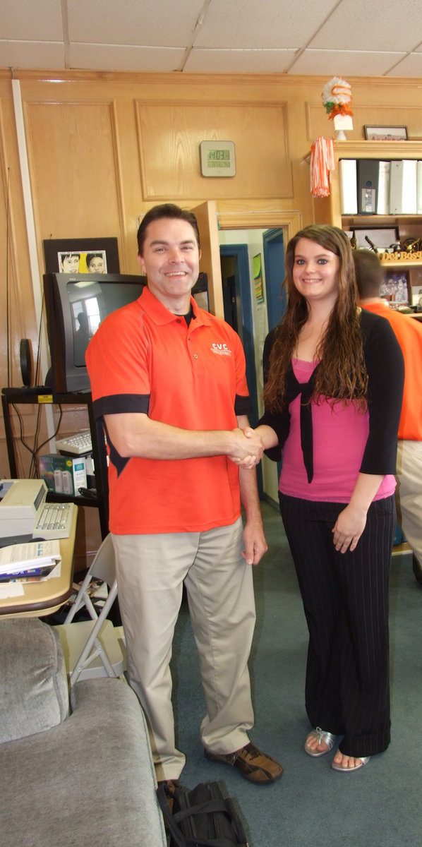 Image: Let’s shake on it — Coach Paul Wisden of Cedar Valley College and Kimberly Gatlin shaking on the deal