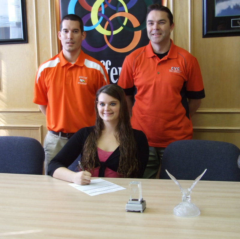 Image: Kimberly happily signing — Coach Hernandez, Kimberly Gatlin and Coach Wisden