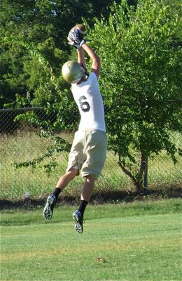Image: Holden on — Jase Holden leaps for the catch.