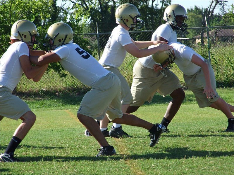 Image: Linemen go at it — Italy’s lean and mean lineman get their shots in despite not wearing shoulder pads.