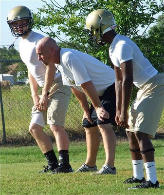 Image: Coaching the backers — Linebackers Kyle Wilkins and Jasenio Anderson receive instruction from defensive coordinator Jeff Richters.