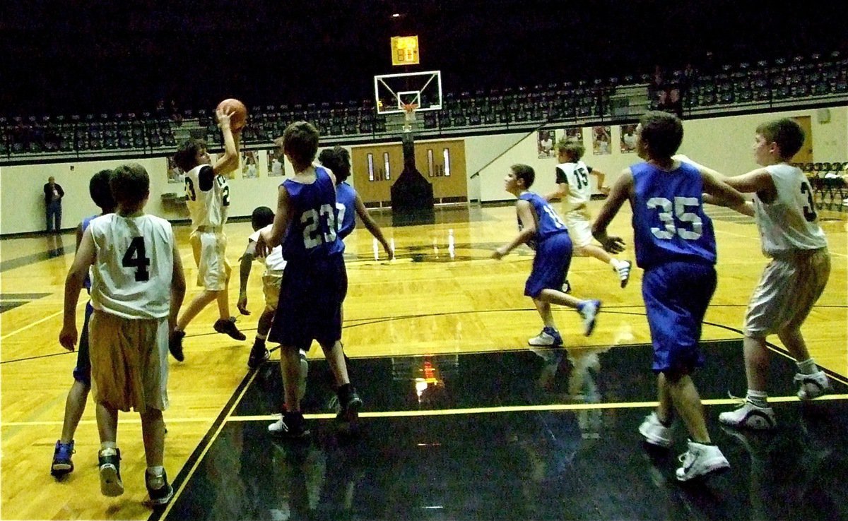 Image: Womack hustles — Mason Womack(23) grabs a loose ball while Thomas Crowell(4) and Brandon Connor(3) battle in the paint.