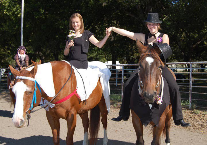 Image: Best Overall Costume — Courtney Griffith of Midlothian and Elizabeth Terry of Waxahachie won the Best Overall Costume at the Flying Dollar Ranch Halloween Horse Show as the Wedding Party with their horses dressed as a bride and groom while they were the best man and maid of honor.