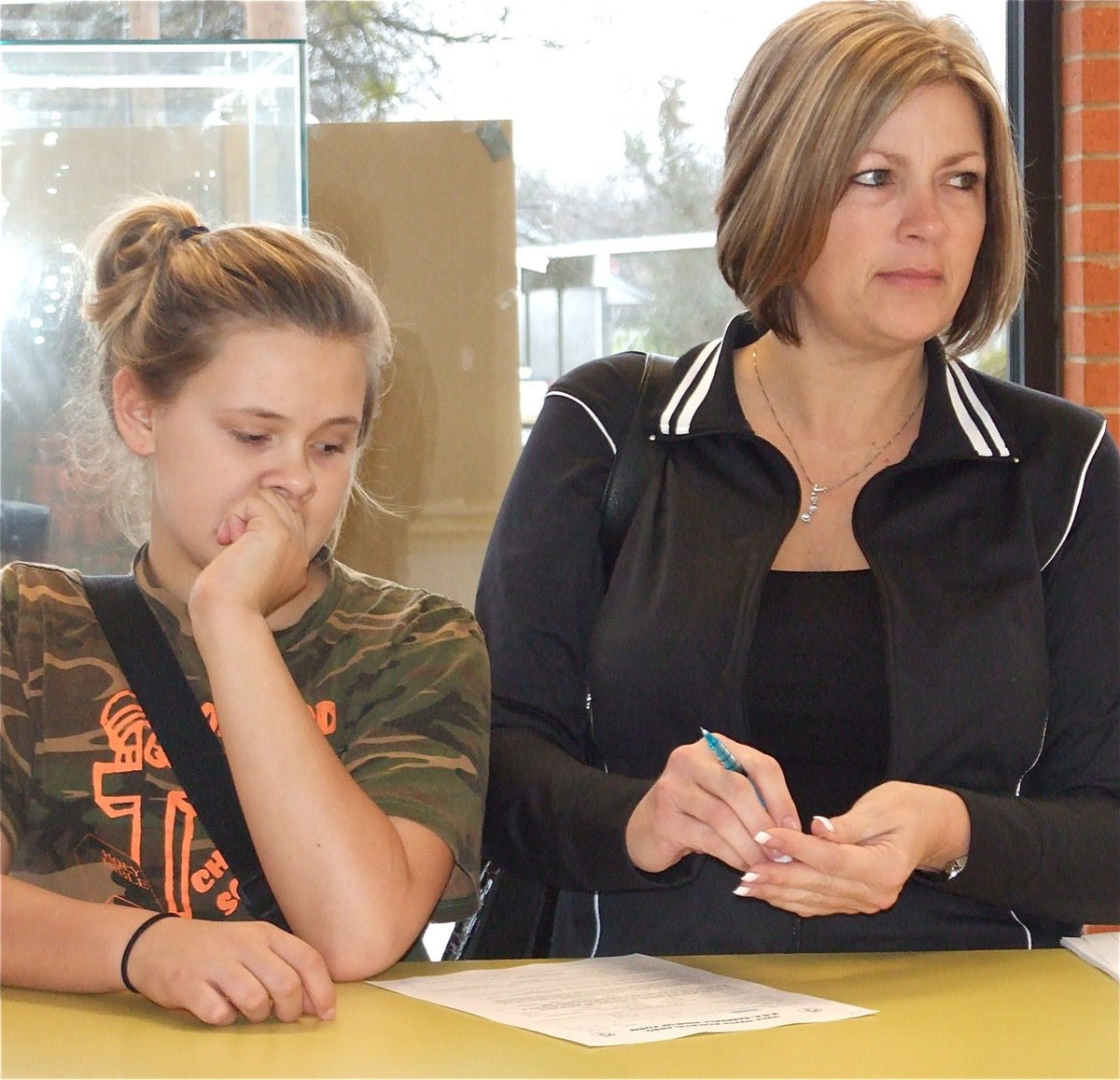 Image: Lillie &amp; Debra — Lillie Perry and her mom, IYAA Board Member Debra Perry, get Lillie signed up for IYAA Softball during the basketball games on Saturday.