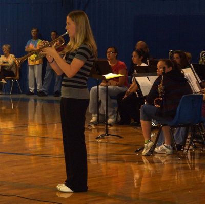 Image: Heather Bledsue — 7th grade band officer Heather Bledsue playing “Taps”