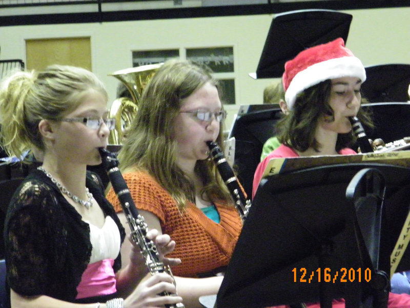 Image: Clarinets abounding — Halee Turner, Samantha Owens, and Kaci Bales perform with the 7th grade band at the 2010 Italy Gladiator Regiment Band Christmas concert.