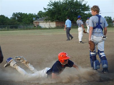 Image: Playing it safe — Teague’s Timmy Campbell plays it safe by sliding home while Corsicana Tigers-Blue catcher Zach Rash looks on. With 3 triples under his belt already, Campbell hit 3 singles against Corsicana on Saturday.