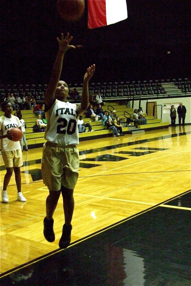 Image: Wilson warms up — Italy’s 8B Girls team member Tylar Wilson(20) shoots a pre-game layup before her squad’s matchup with Axtell.