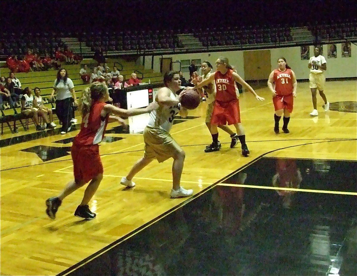 Image: Hustle play — Bailey DeBorde grabs a loose ball and searches for a teammate.