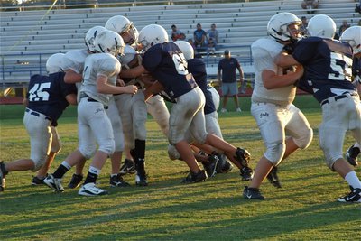Image: Follow us — Ryan Connor(17) tries to break away from a pile of Cougars while Cody Boyd, John Escamilla(7) and Kelton Bales(60) try clearing the way.