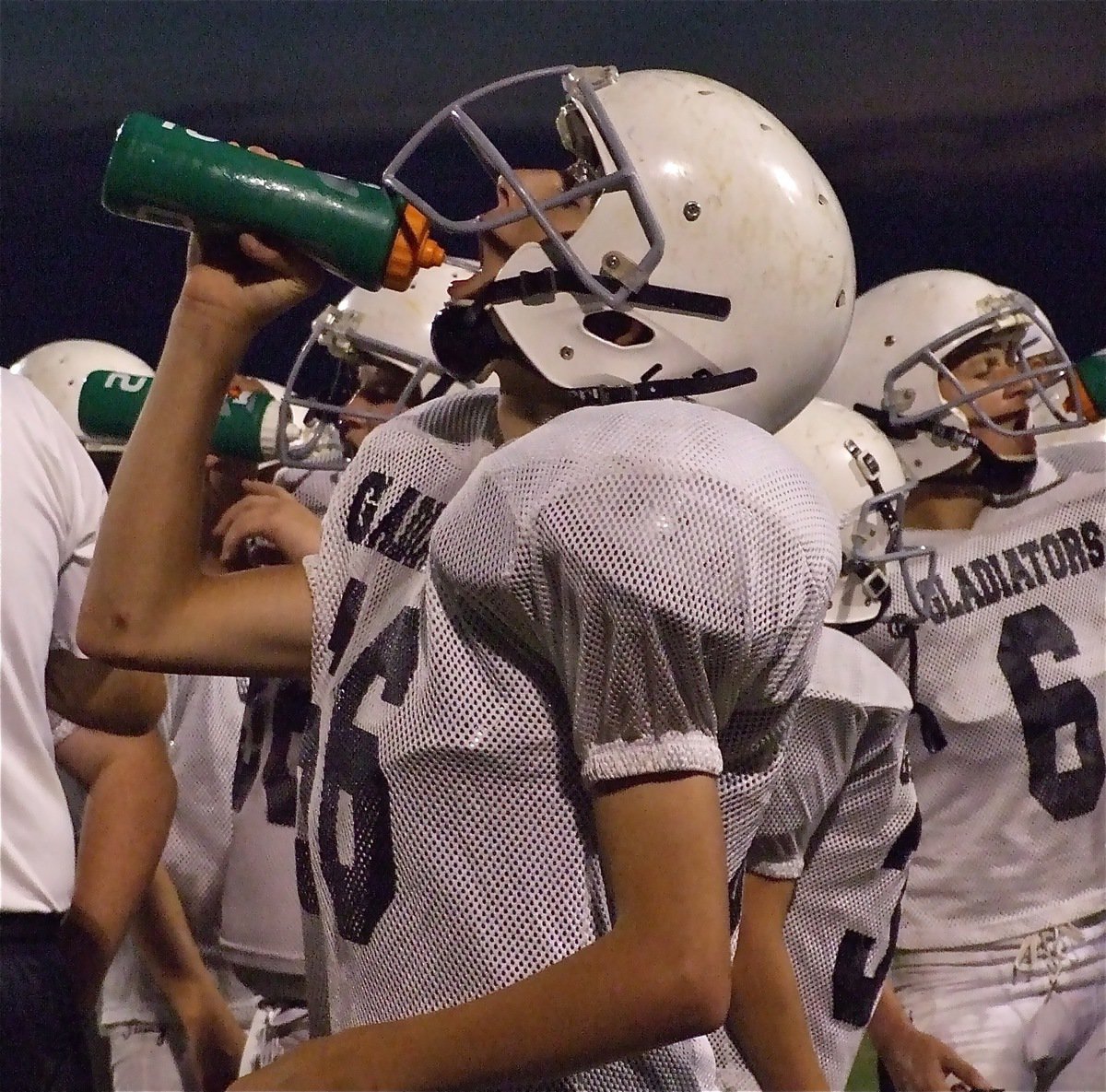 Image: Water please — Jordan Lemire(66), Colton Petrey(6) and John Byers(56) have a synchronized water break.