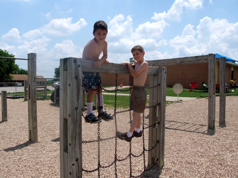 Image: I’m At The Top — These boys are having fun climbing high.