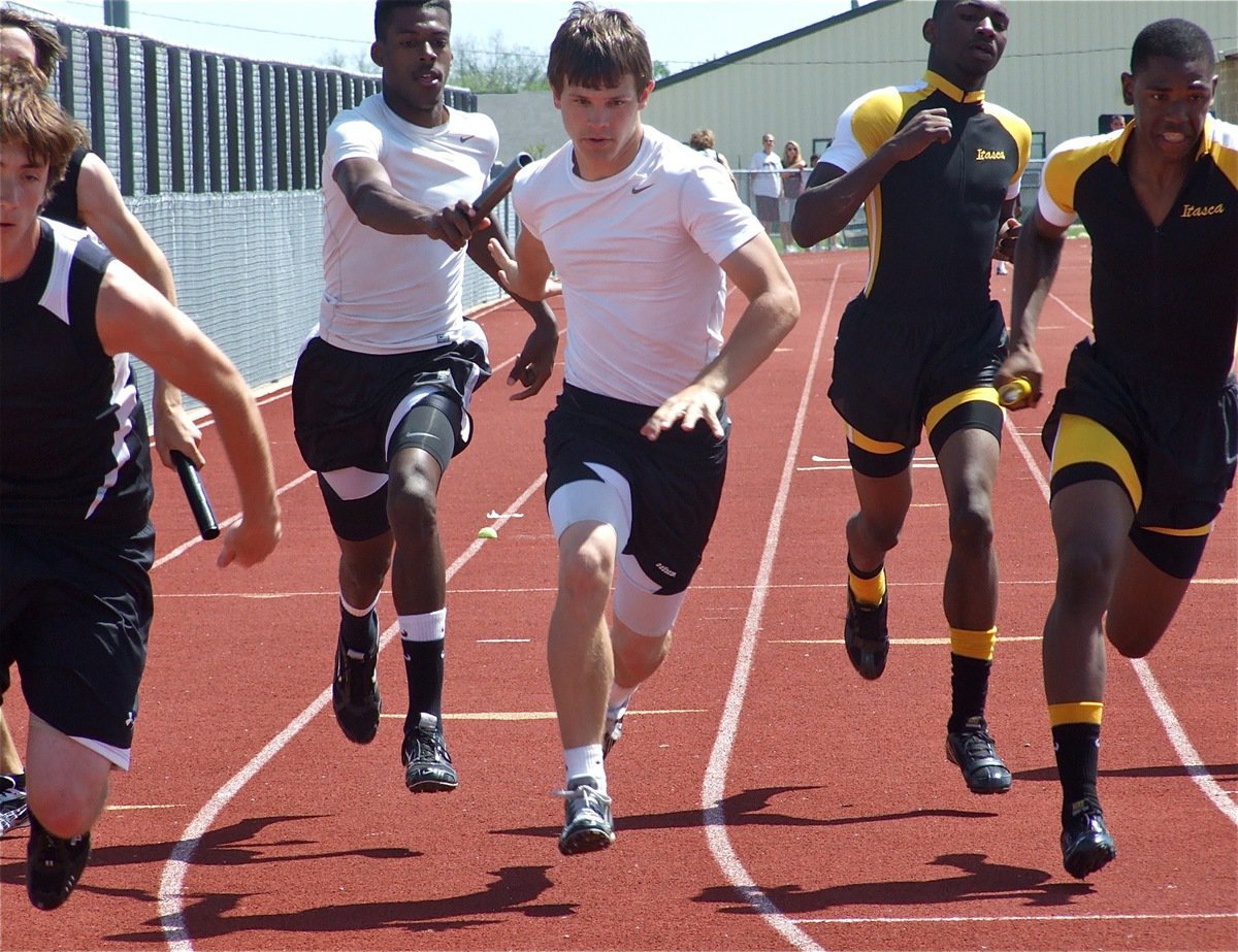 Image: The exchange — John Isaac hands the baton to Chase Hamilton as the two helped Italy’s 4 × 100m relay team finish in 3rd Place and advance to Regional.