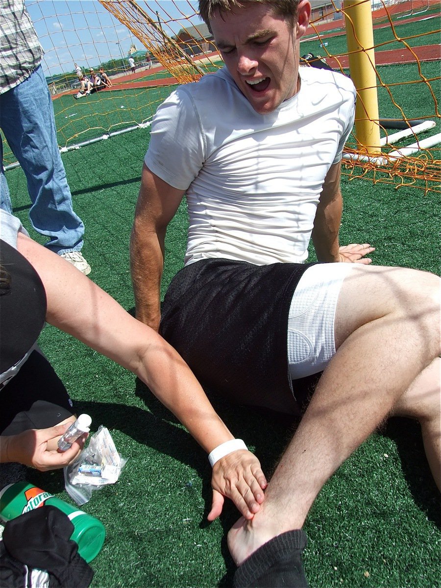 Image: That burns! — Honorary nurse DeeDee Hamilton treats the damage done to Ryan Ashcraft during his 800m race.