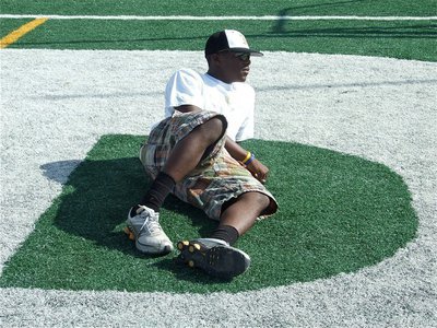 Image: Big “D” relaxes — Desmond Anderson seems right at home resting on the letter D, in “Indian”, which was painted across the Alvarado endzone.
