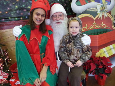 Image: Merry Christmas — Santa and one cute elf, Anna Viers, along with Nicolas Svehlak wishes you Merry Christmas.