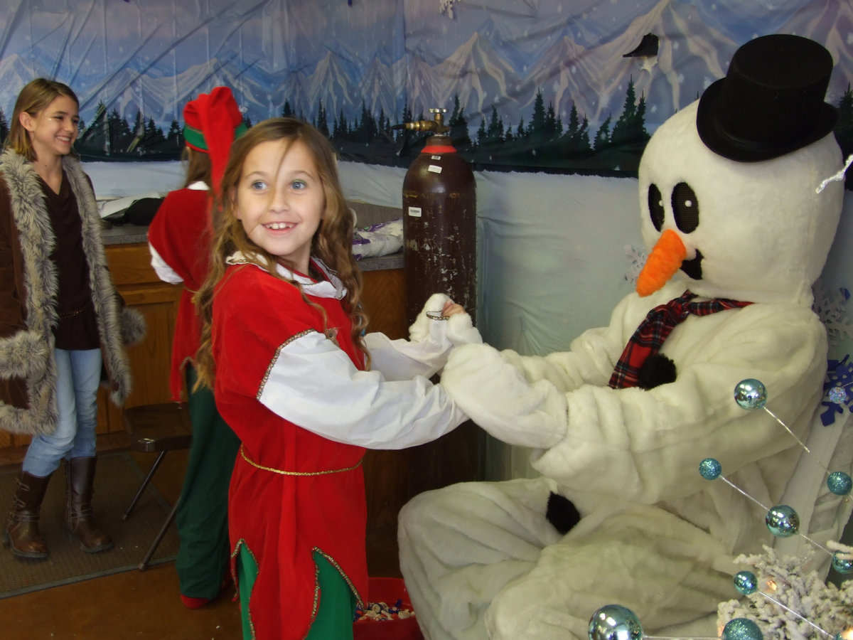 Image: Frosty and Friend — Suffering from the effects of global warming, a more slender Frosty posed for pictures with Festival goers.