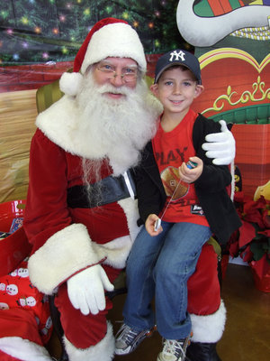 Image: Santa Claus and Garrett — One happy little boy, Garrett Everett sitting on Santa’s lap.