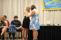 Image: Lexi and Kaytlyn — Lexie Miller and Ryan Ashcraft present the new inductees their membership pins.  Kaytlyn Bales received hers too.
