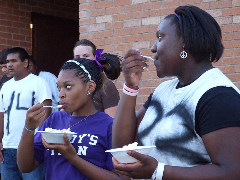 Image: Mmmmm! — Kyonne Birdsong and Jimesha Reed help themselves to some ice cream.