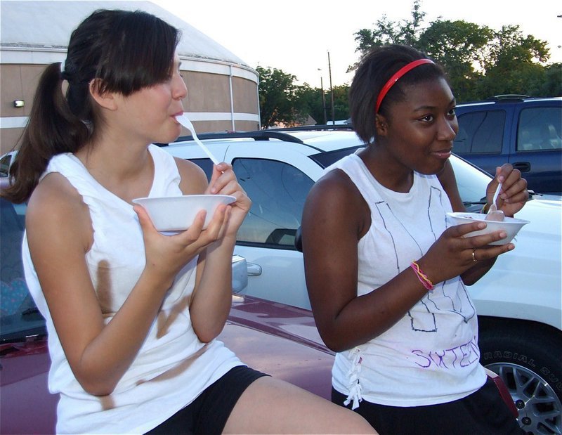 Image: Can’t talk now — Paola Mata and Chante Birdsong enjoy some light gossip and some good ice cream.