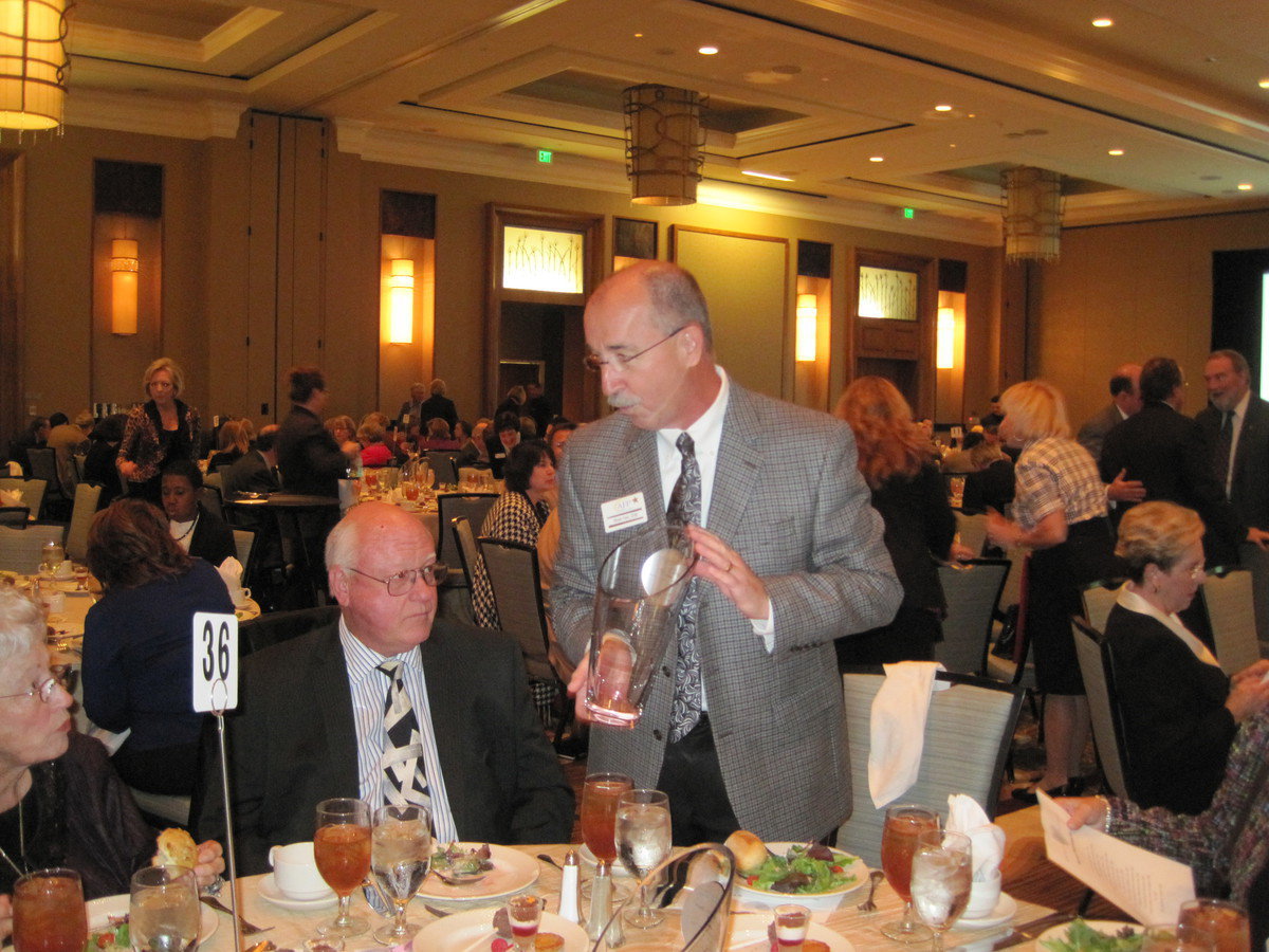 Image: Executive Director Vinsen Faris presents the Burton Family with their award.