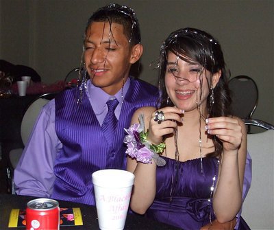 Image: Adding to the decor — Juan Hernandez and his beautiful prom date get covered in decorations.