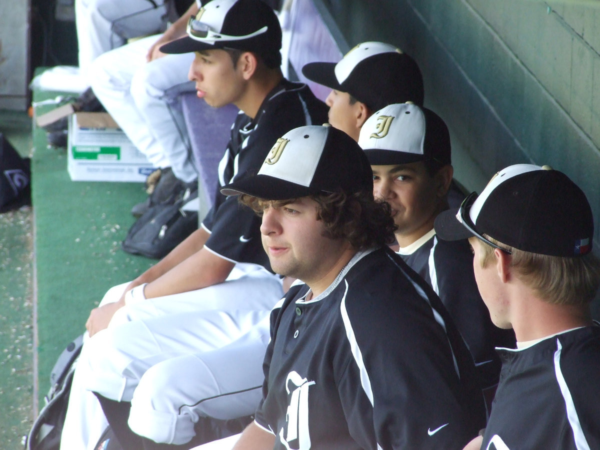 Image: Somewhere in the dugout — Ivan Roldan looks on as the Varsity Gladiators play against the Hawley Bearcats.