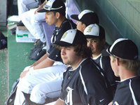 Image: Somewhere in the dugout — Ivan Roldan looks on as the Varsity Gladiators play against the Hawley Bearcats.