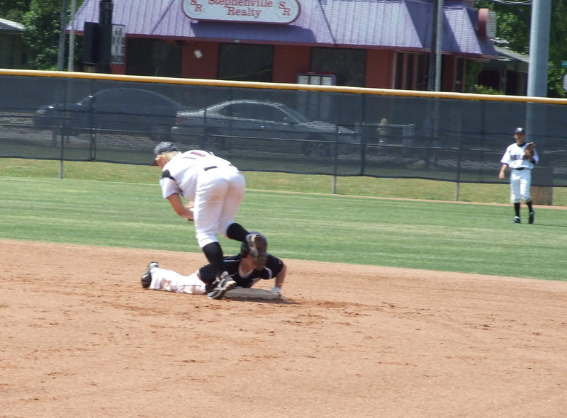 Image: Dan hangs on — Dan Crownover slides back to second.