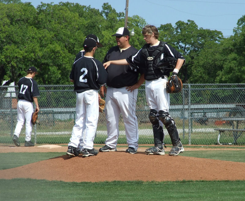 Image: Just a few words — Coach Coker takes a moment with his infield.