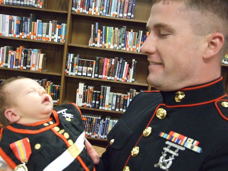 Image: Like father, like son — Marine Sgt. Jacob Simon holds baby Easton, 2 weeks old.  It seems that Easton is a chip off the old block.  2005 IHS Graduate, Simon, enlisted  in the Marines in 2006.