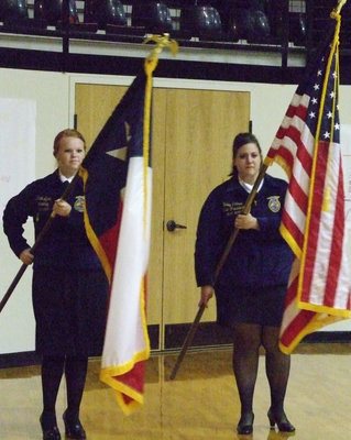 Image: Color guard — Katie Byers and Haley Pittmon carefully take the colors to the ceremony.