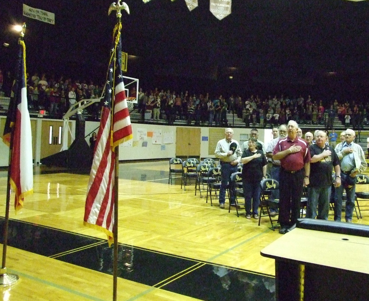 Image: Local veterans honor our flag — Local veterans representing different branches of the military pay their respects to the colors.