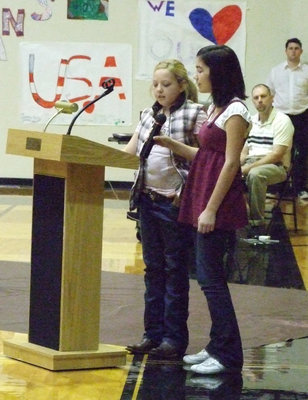 Image: “God Bless America” — Brycelen Richards and Kasey Bales take their turn at the microphone.