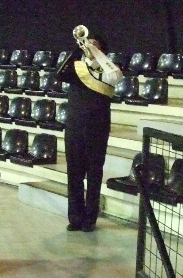 Image: “Day is Done” — Taz Martinez ends the ceremony with “Taps”.