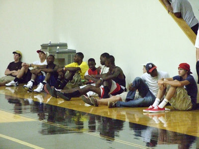 Image: Some friends stop by — The Gladiators take a minute and watch the game after their football practice.