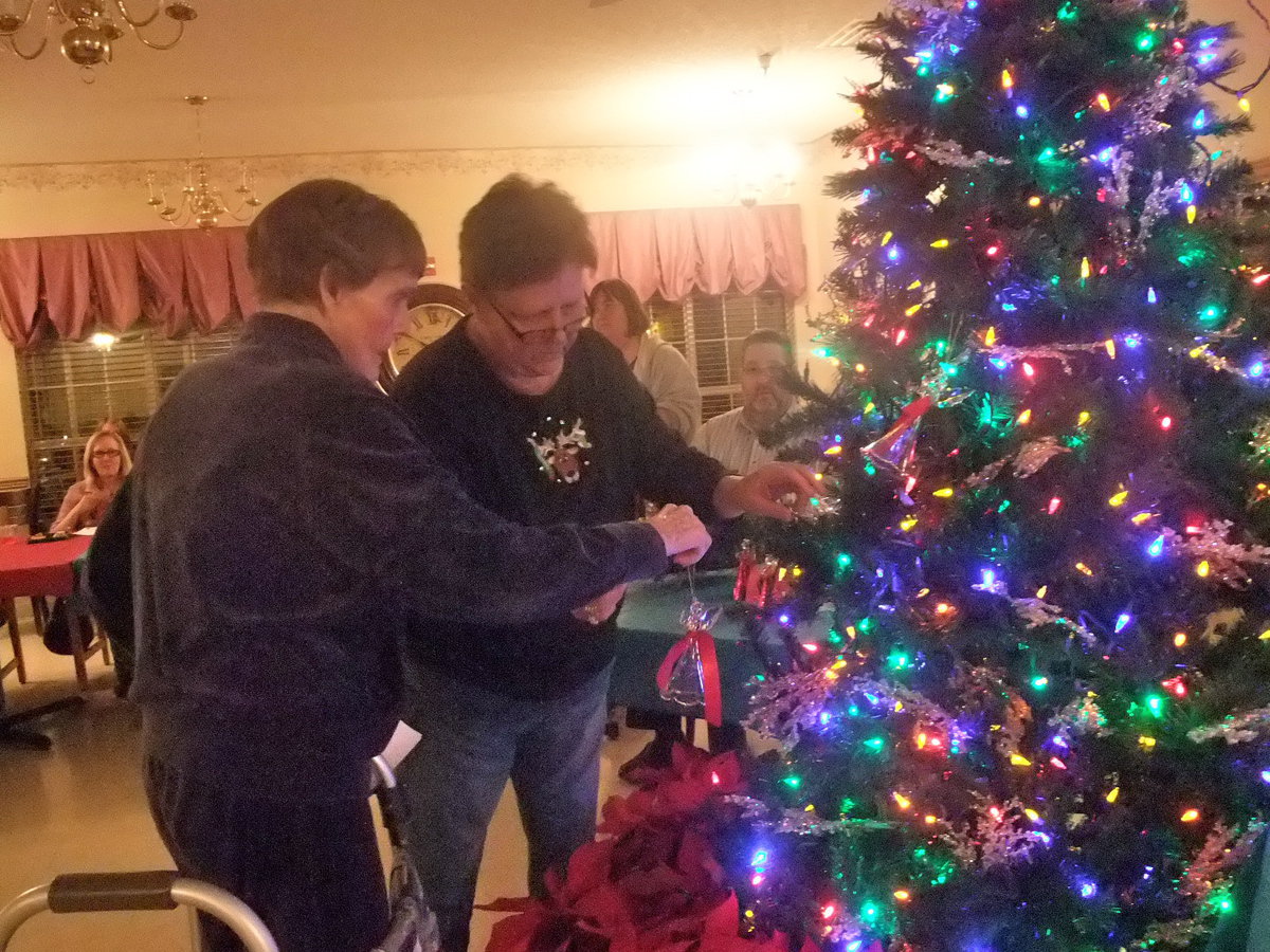 Image: Betty Boyd &amp; Debbie Knott — Betty Boyd along with Debbie Knott’s help putting Emma Davis’s angel on the tree.