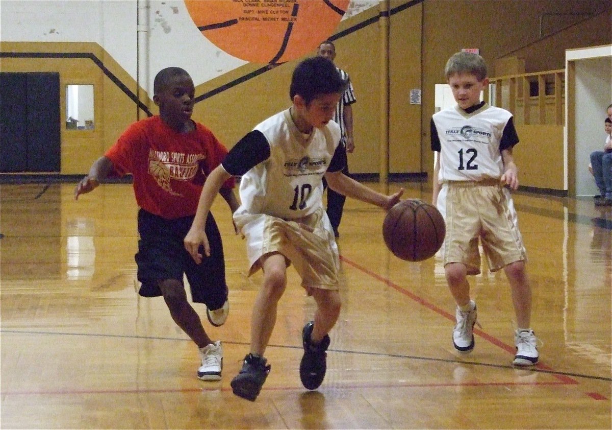 Image: Ball control — Alex Hernandez(10) manages to bring the ball up the court with a Hillsboro Red defender on his hip pocket as teammate Garret Janek(12) stays on the wing.