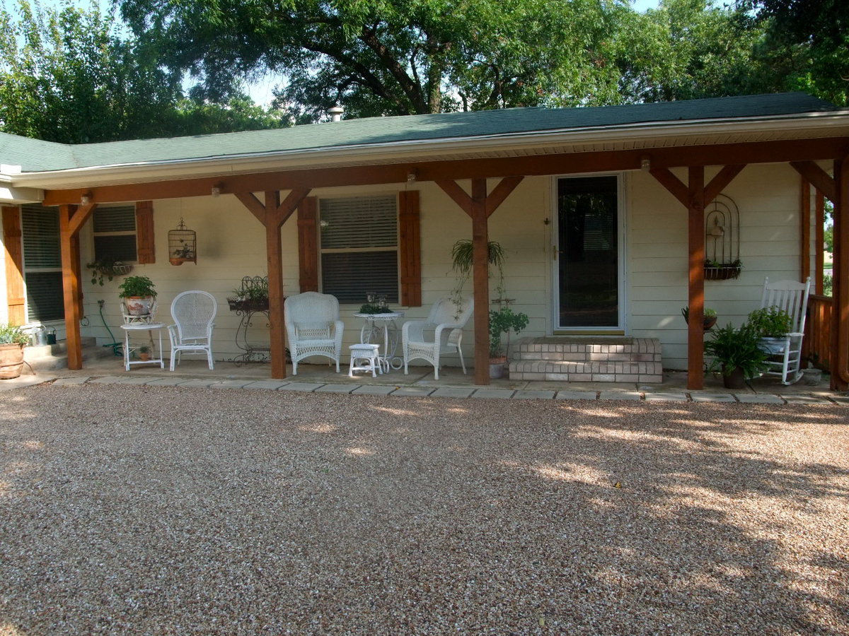 Image: Side View of House — Beautiful porch to while away the hours.