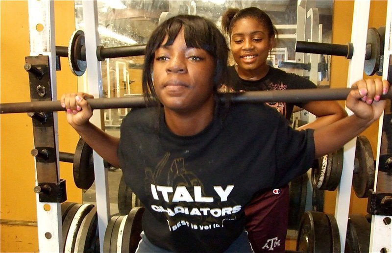 Image: Kendra and Ashley — Kendra Copeland builds up her muscles while Ashley Harper waits for her turn.