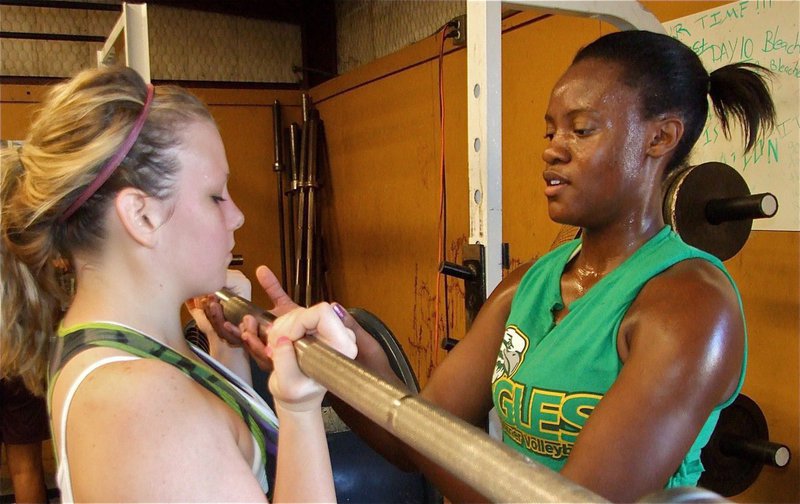 Image: Getting a lift — Cassi Jeffords gets help with her lift from teammate Brianna Burkhalter.