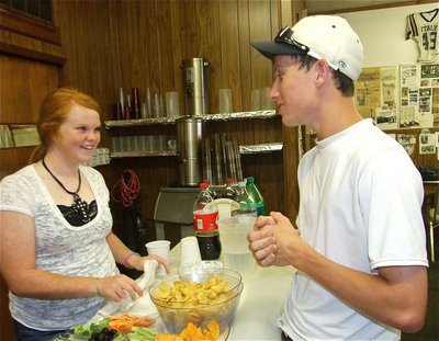 Image: Athletic cousins — Katie Byers offers her cousin Seth Sims a party snack. Katie is a member of the Italy Lady Gladiators Softball Team and Seth plays baseball for Waxahachie High School.