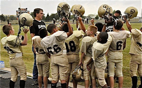 Image: One team! — Head coach Gary Wood and the IYAA B-Team players celebrate their 20-6 win over Hubbard and remain undefeated in their division.